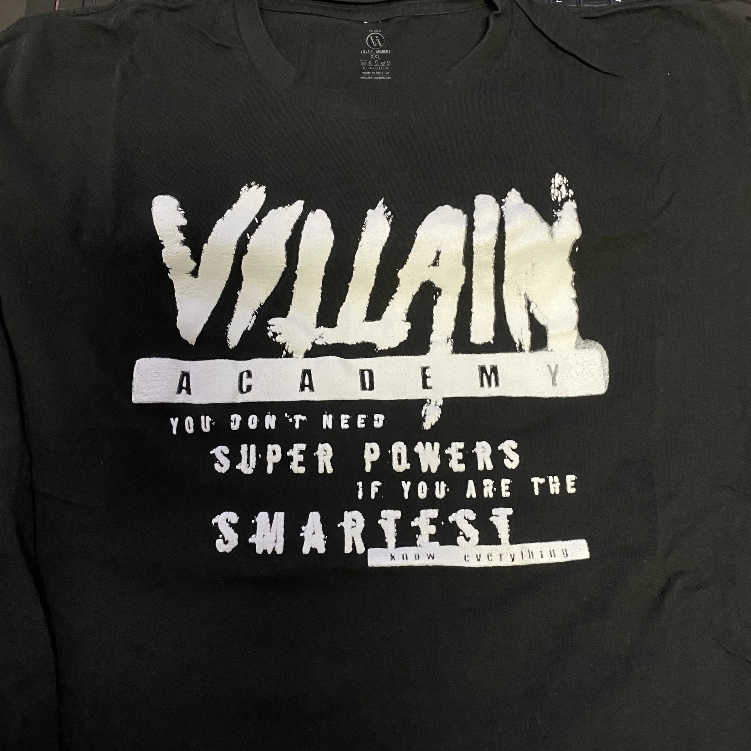 Black Villain Academy tee printed with the brushed VILLAIN ACADEMY wordmark above the line you don't need super powers if you are the smartest
